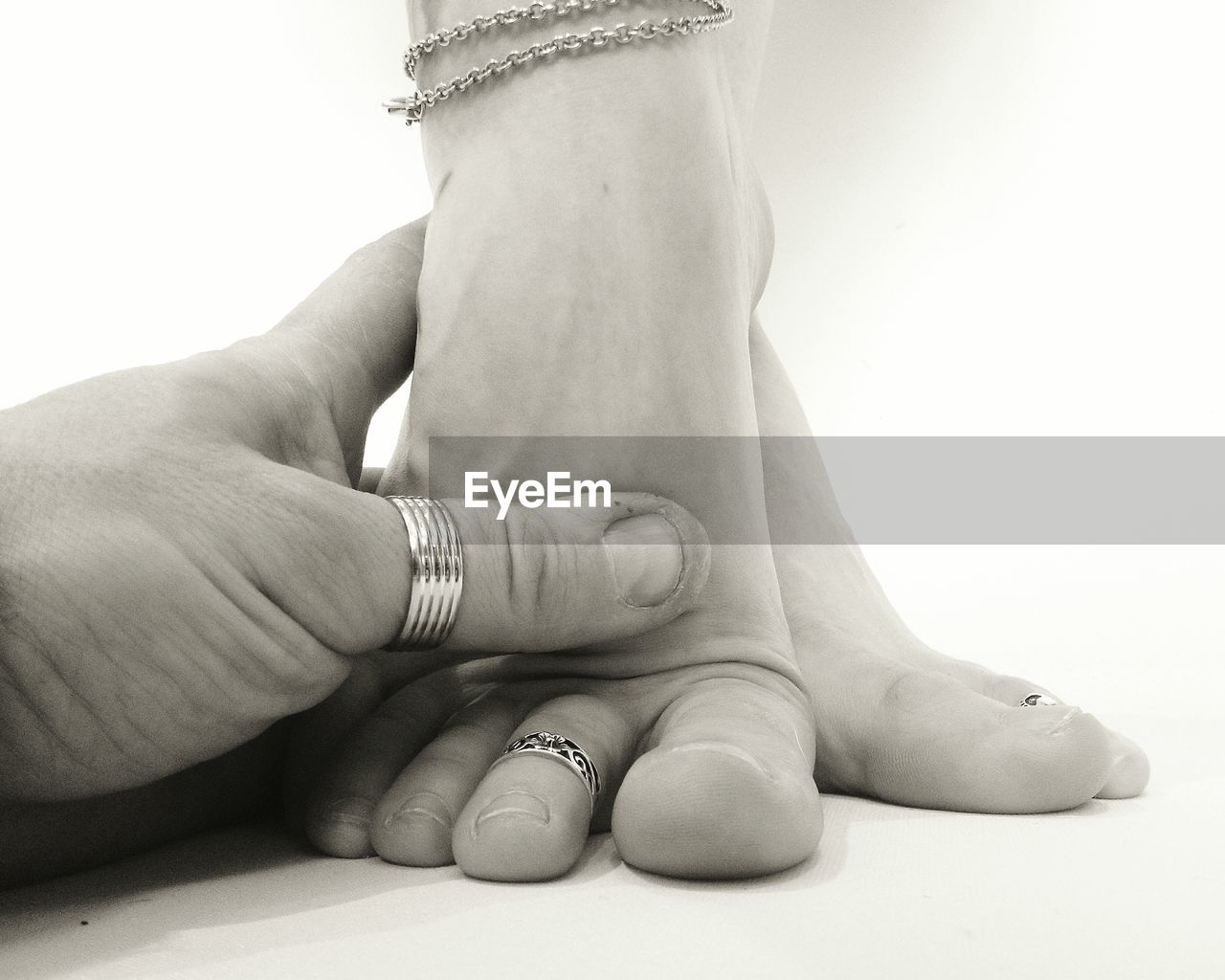 Cropped image of hand holding feet