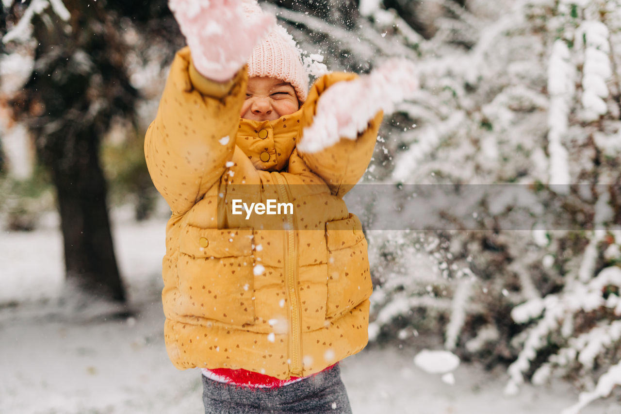 Toddler girl happy with snow day in winter. playing outside on christmas holiday. high quality photo