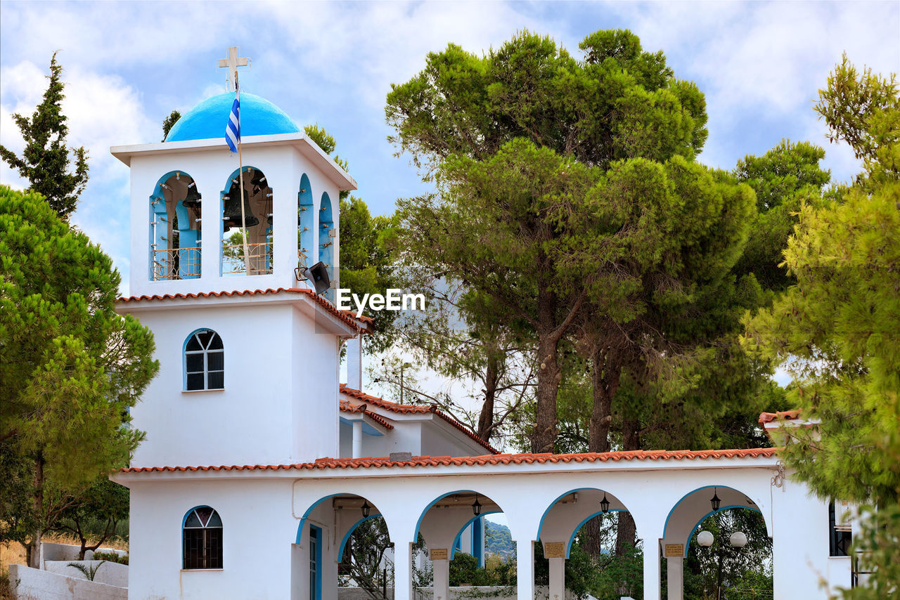 Exterior of the traditional white-blue greek bell tower of a christian orthodox temple in loutraki.