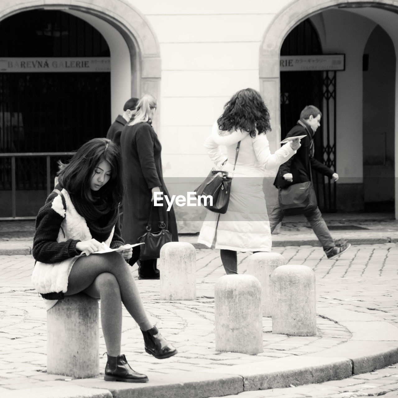 PEOPLE SITTING IN COURTYARD