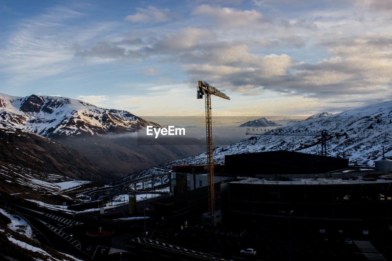 View of cranes on snow covered landscape