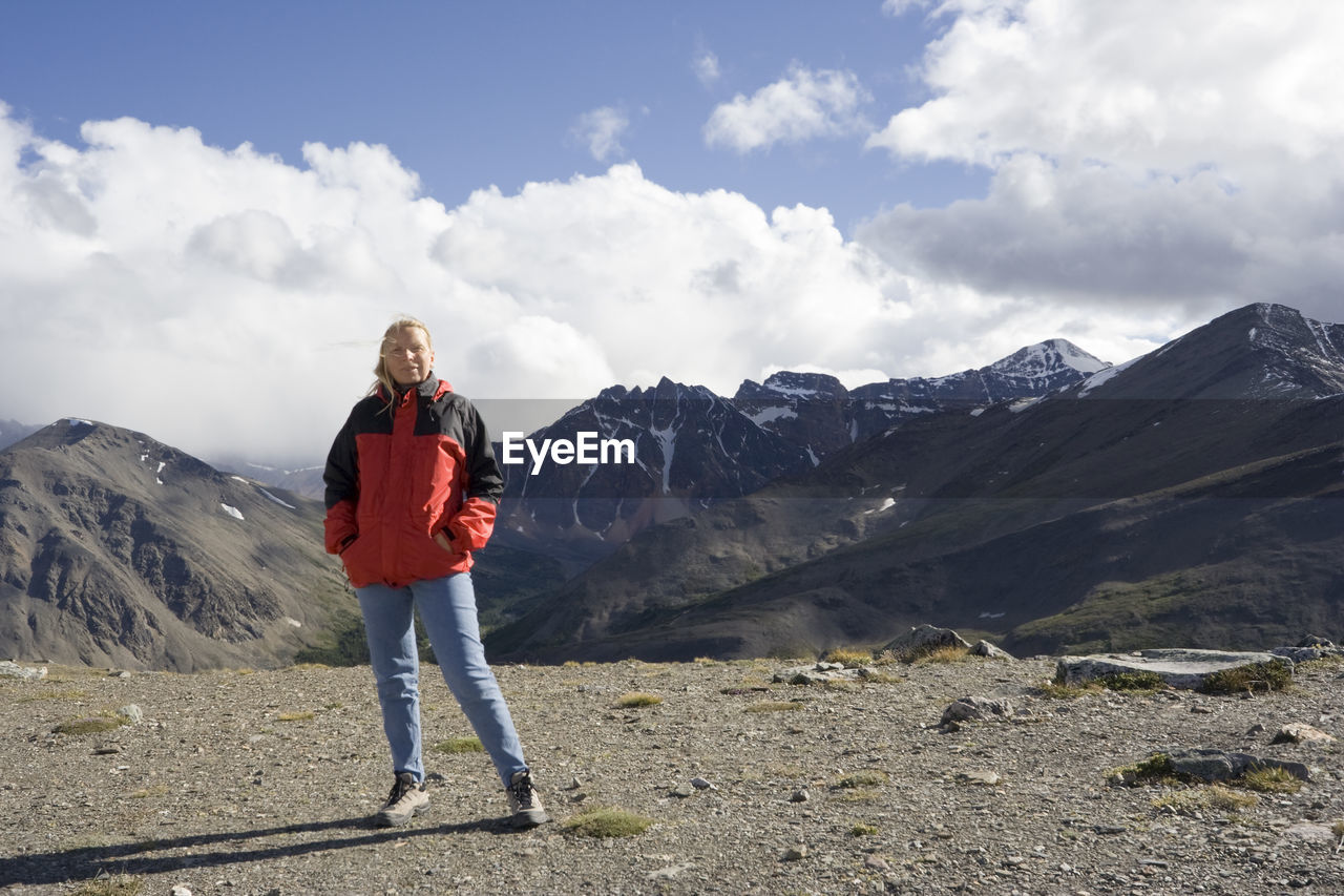 Portrait of woman standing on whistler mountain against sky