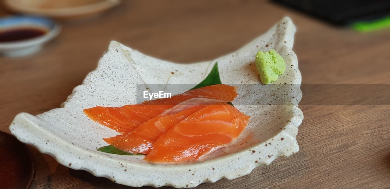 CLOSE-UP OF SUSHI SERVED IN PLATE ON TABLE