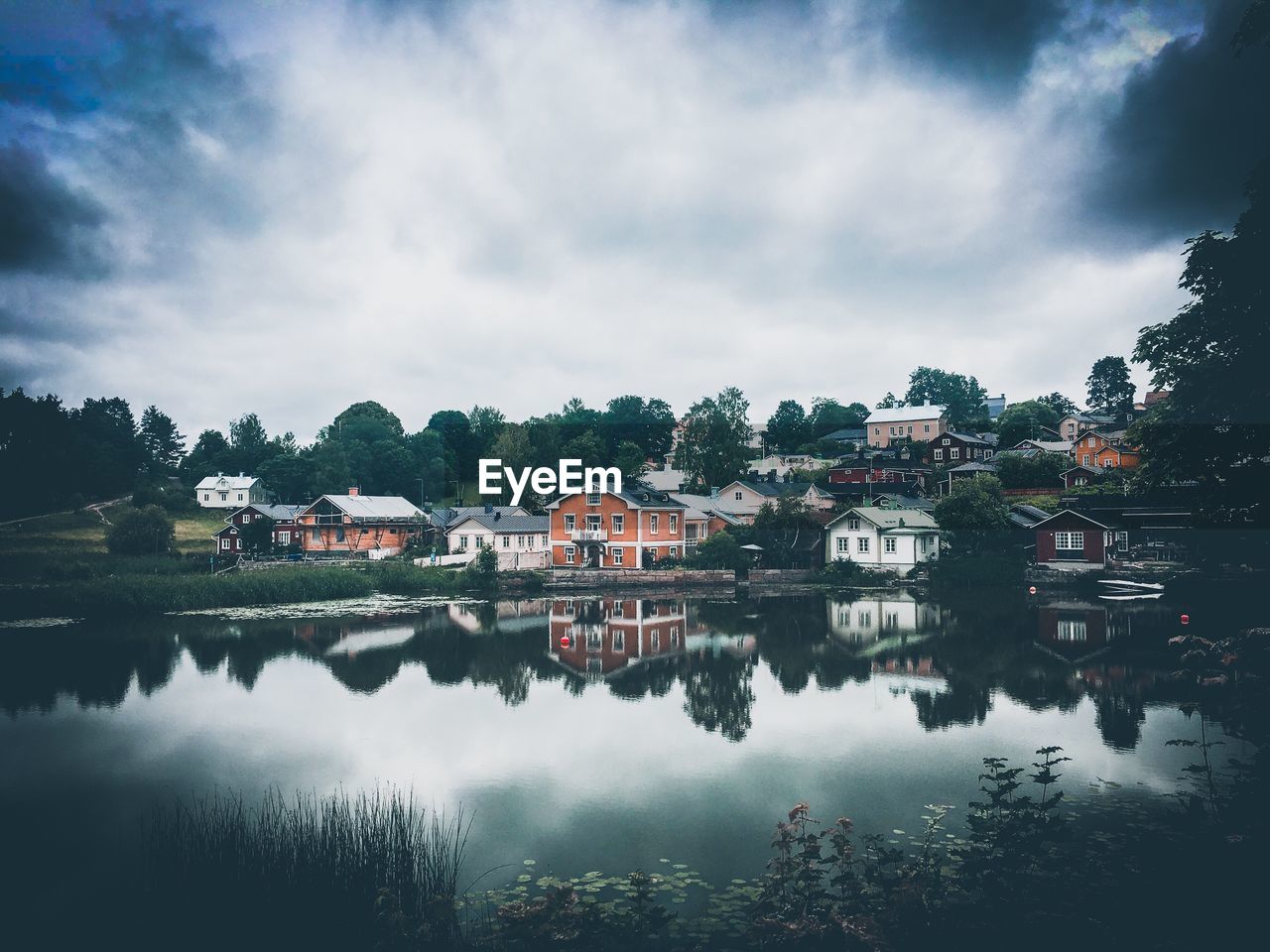 Reflection of buildings in lake against sky