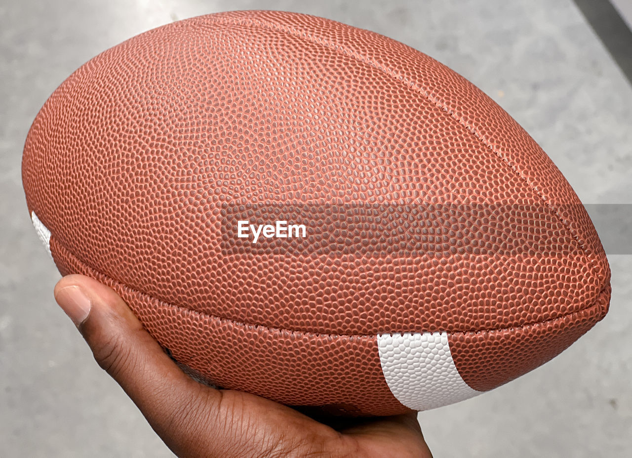 Close-up of hand holding football