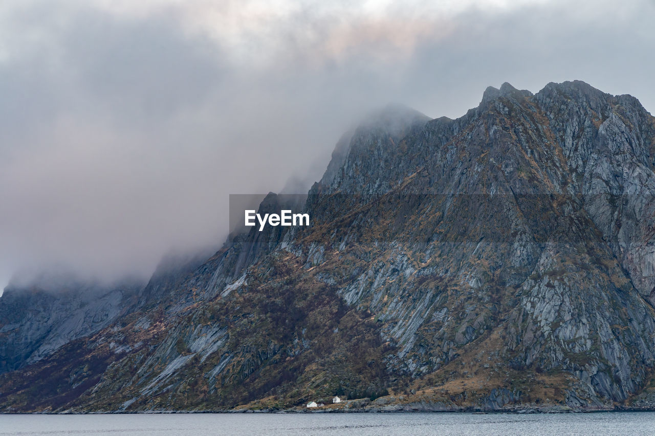 Scenic view of sea and mountains against sky