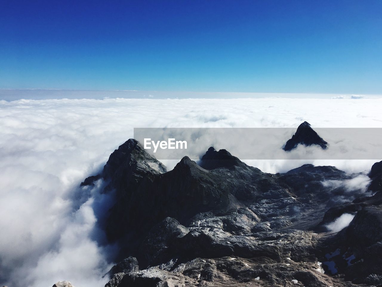 Scenic view of sea and snowcapped mountains against sky