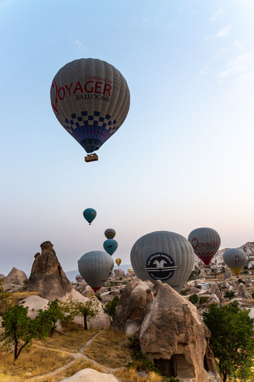 VIEW OF HOT AIR BALLOON FLYING OVER ROCK
