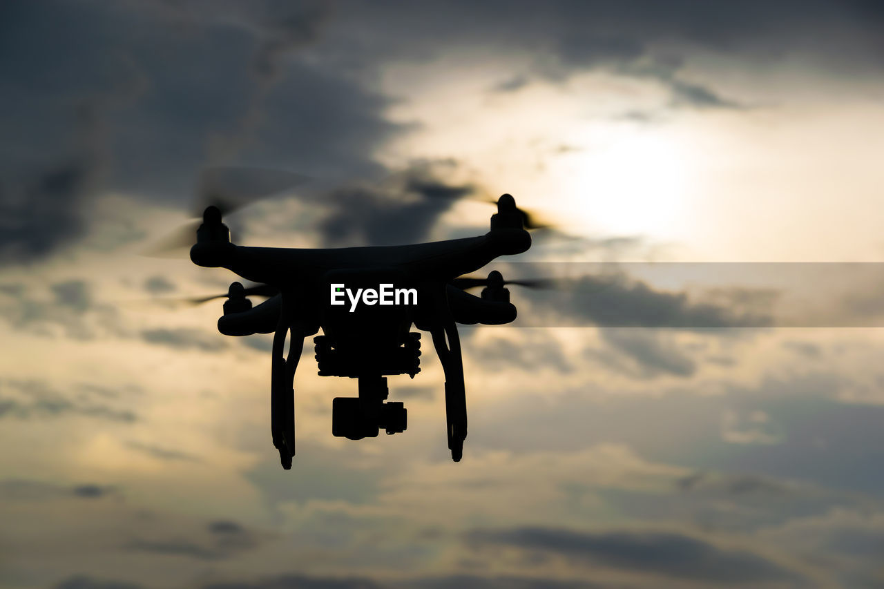 Close-up of drone against sky during sunset