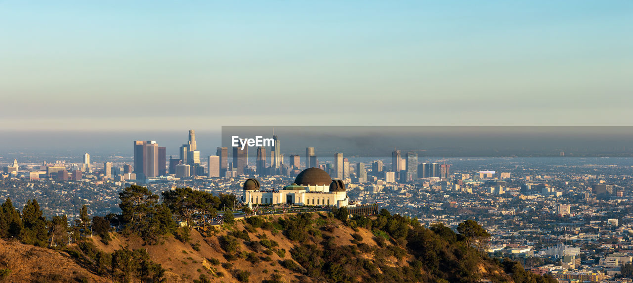The griffith park observatory sits above the downtown los angeles skyline.