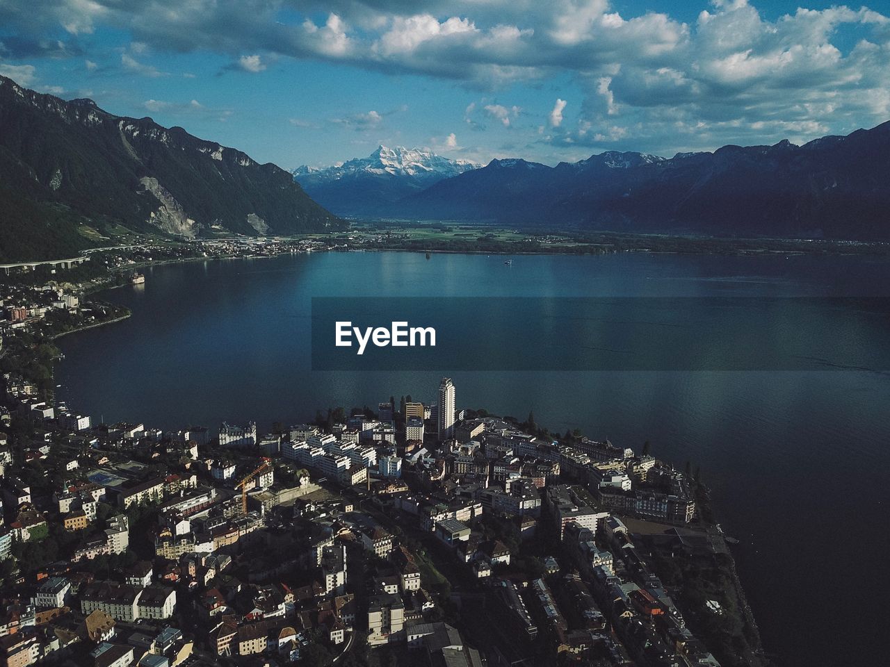 Aerial view of lake and buildings against sky