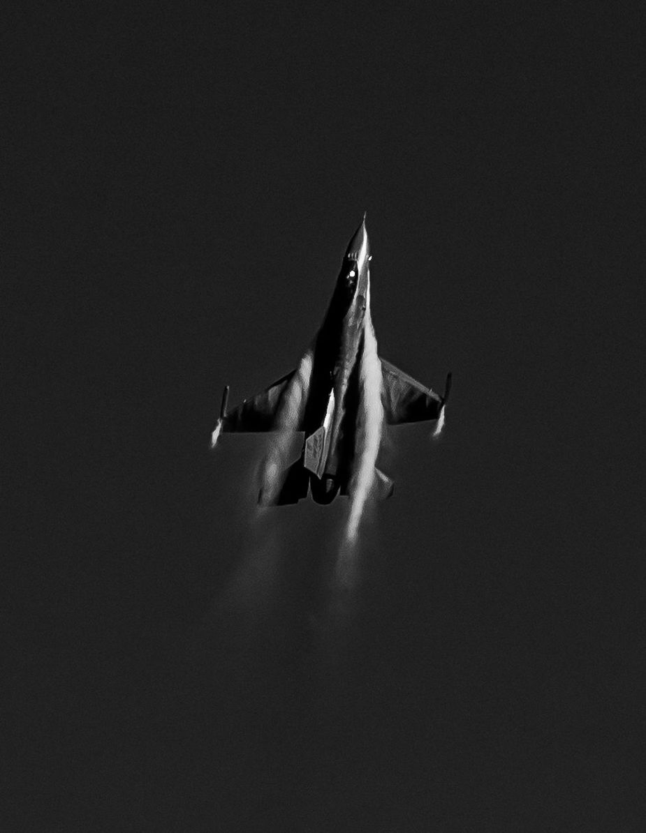 Low angle view of fighter plane flying against sky