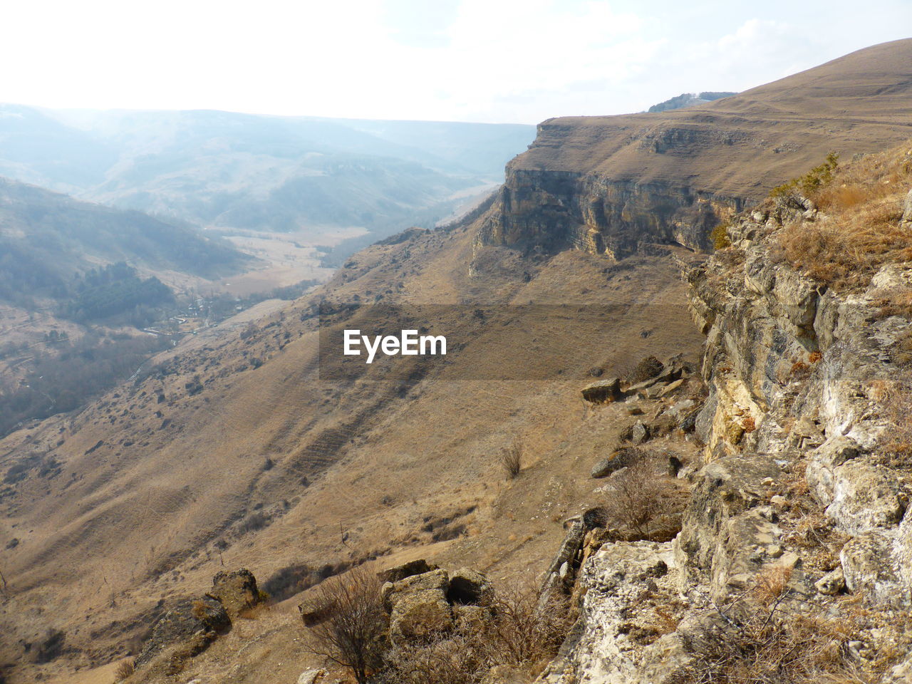 Scenic view of landscape and mountains against sky