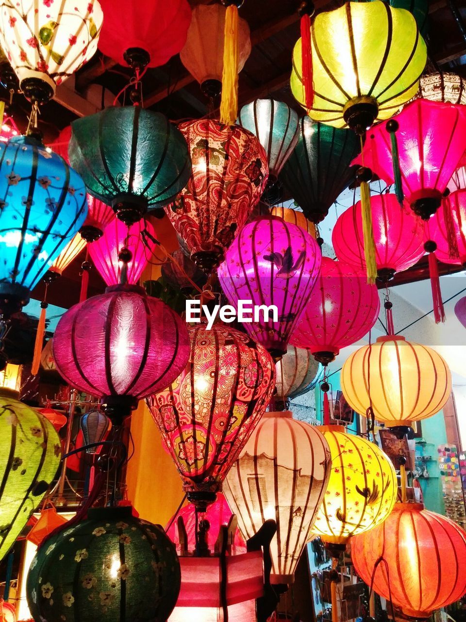 Low angle view of multi colored illuminated lanterns for sale