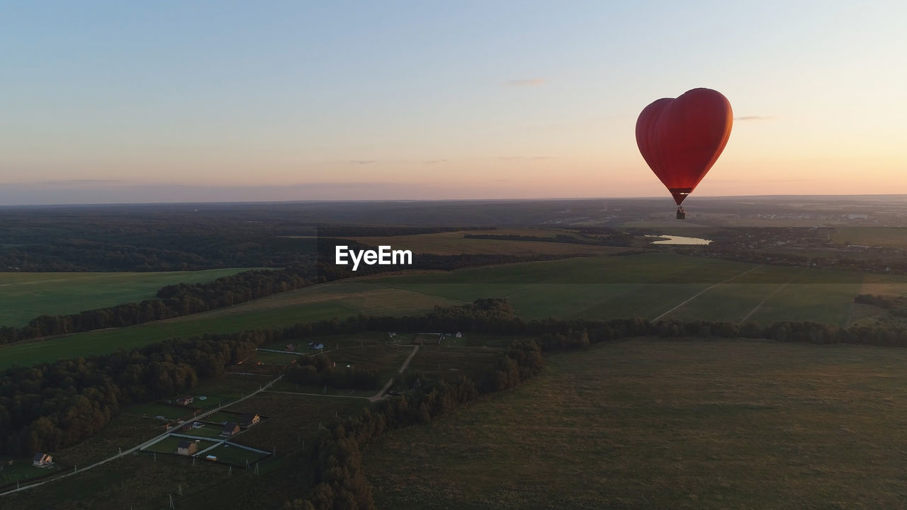 hot air balloons flying against sky during sunset