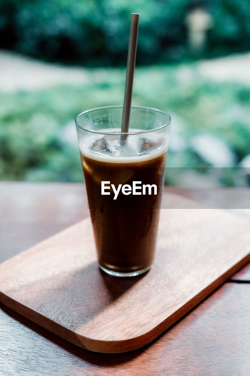 Iced hojicha tea on woonden table.