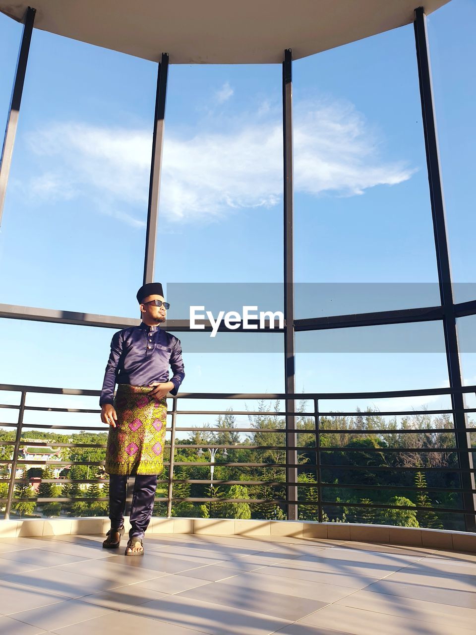 Man standing in pavilion against sky