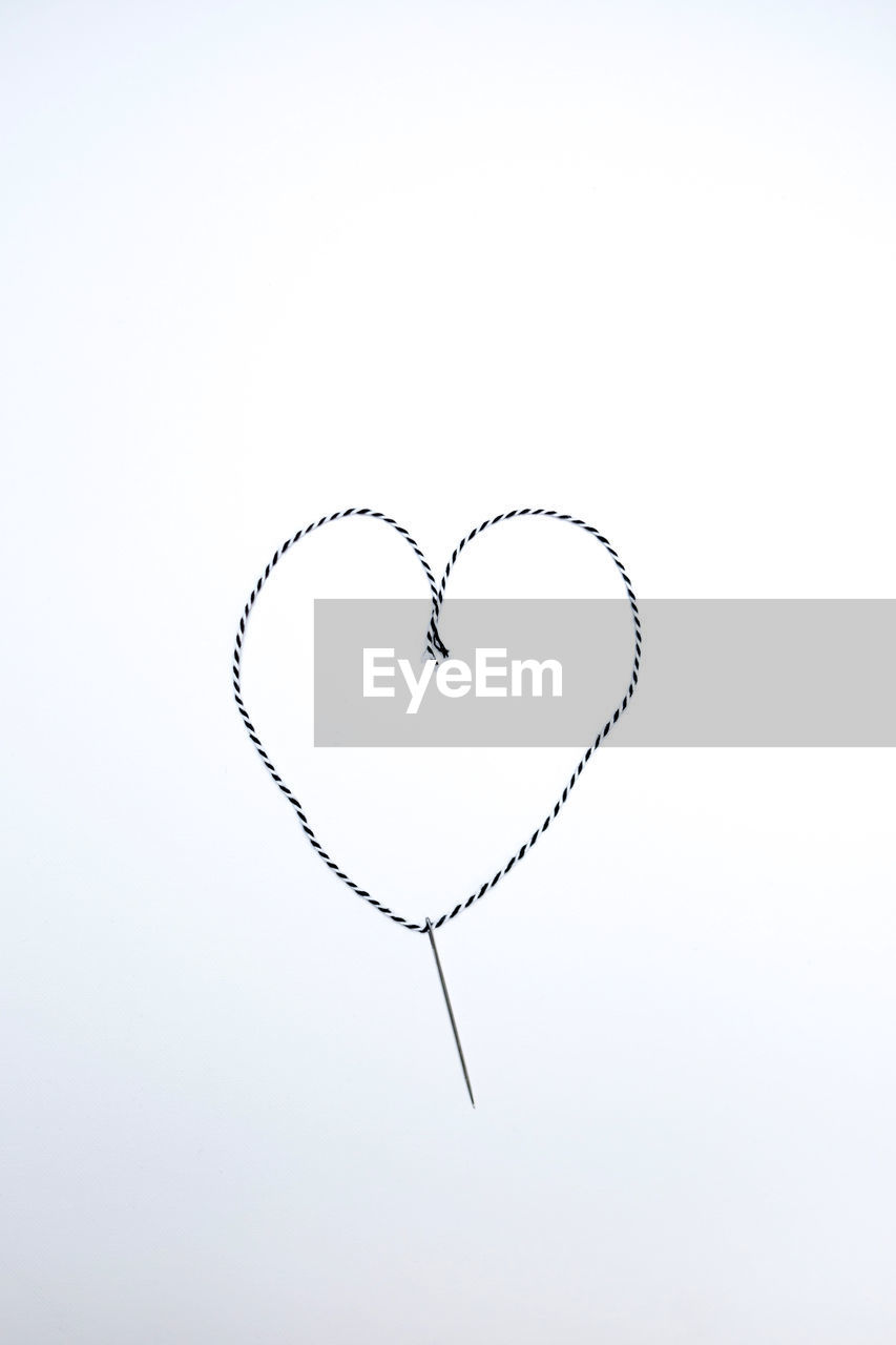 High angle view of a pin with s heart shaped thread. diy project.