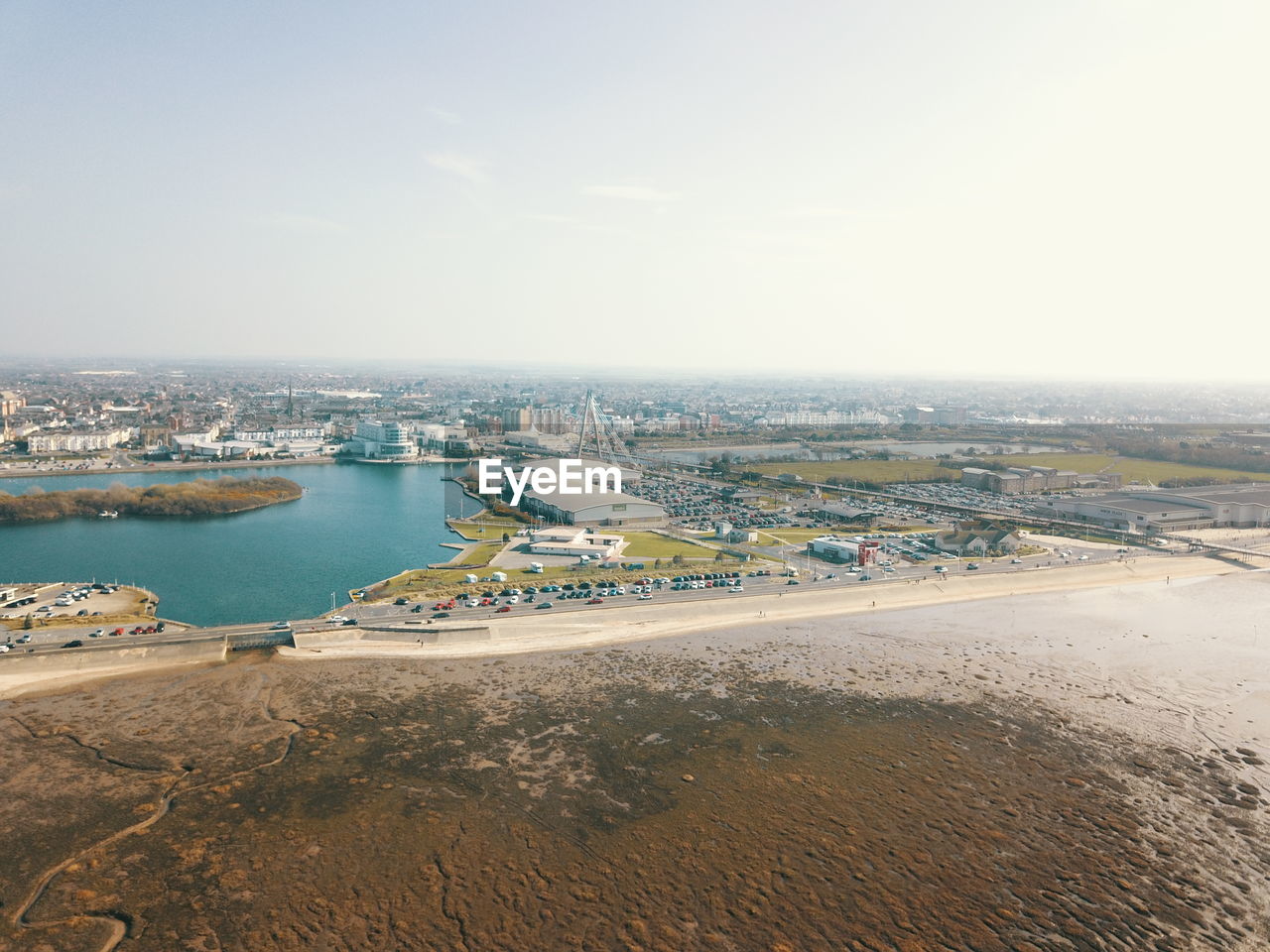 HIGH ANGLE VIEW OF BEACH AGAINST SKY IN CITY