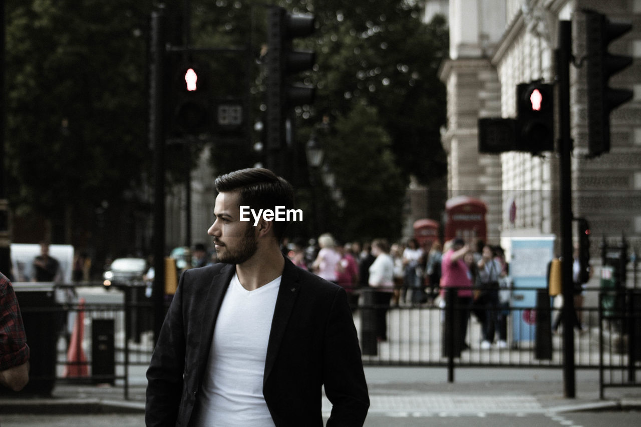 Businessman standing on street in city