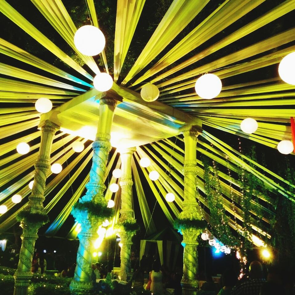 LOW ANGLE VIEW OF ILLUMINATED LIGHTS IN DARK
