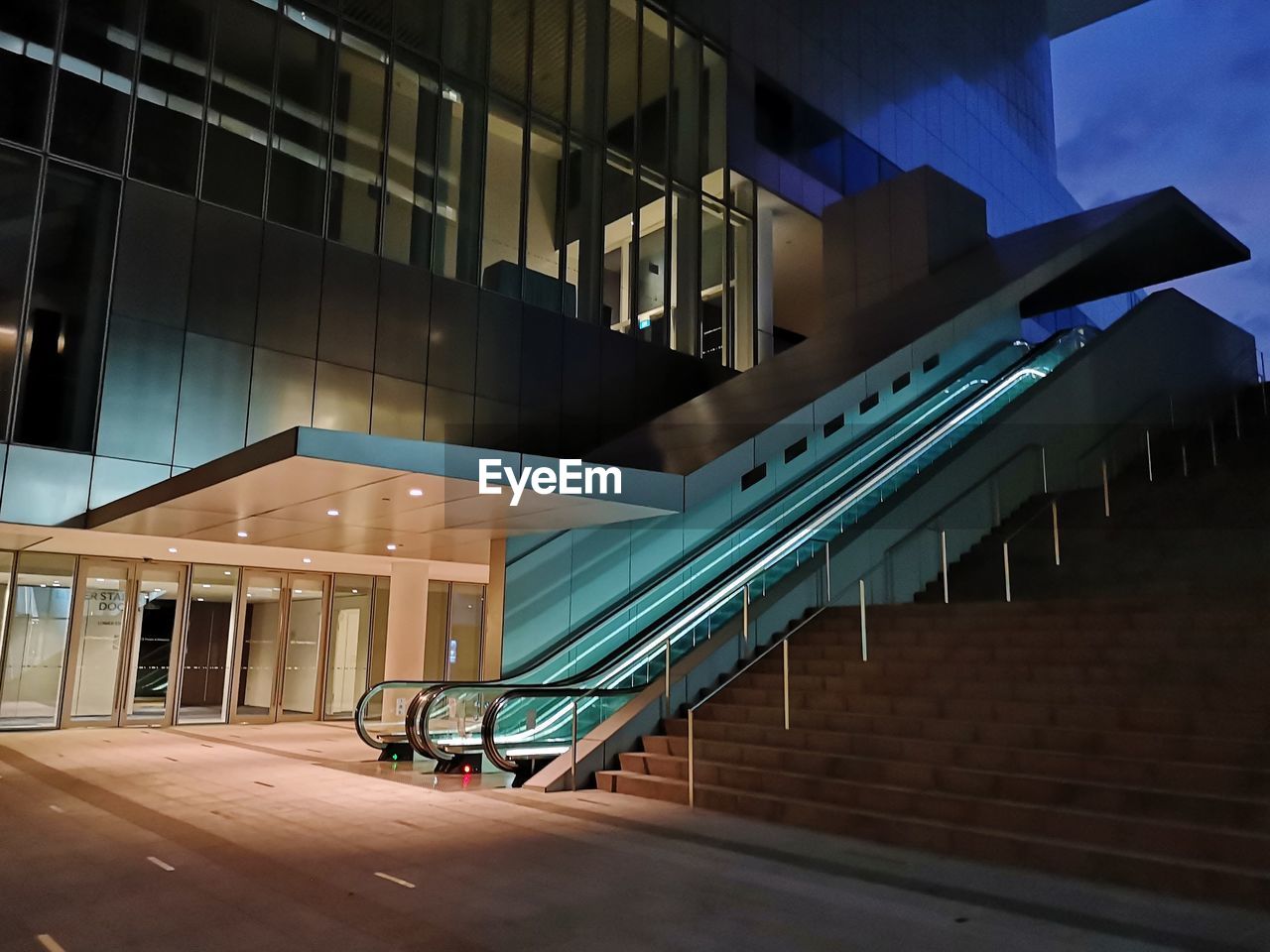 LOW ANGLE VIEW OF ILLUMINATED STAIRCASE IN BUILDING