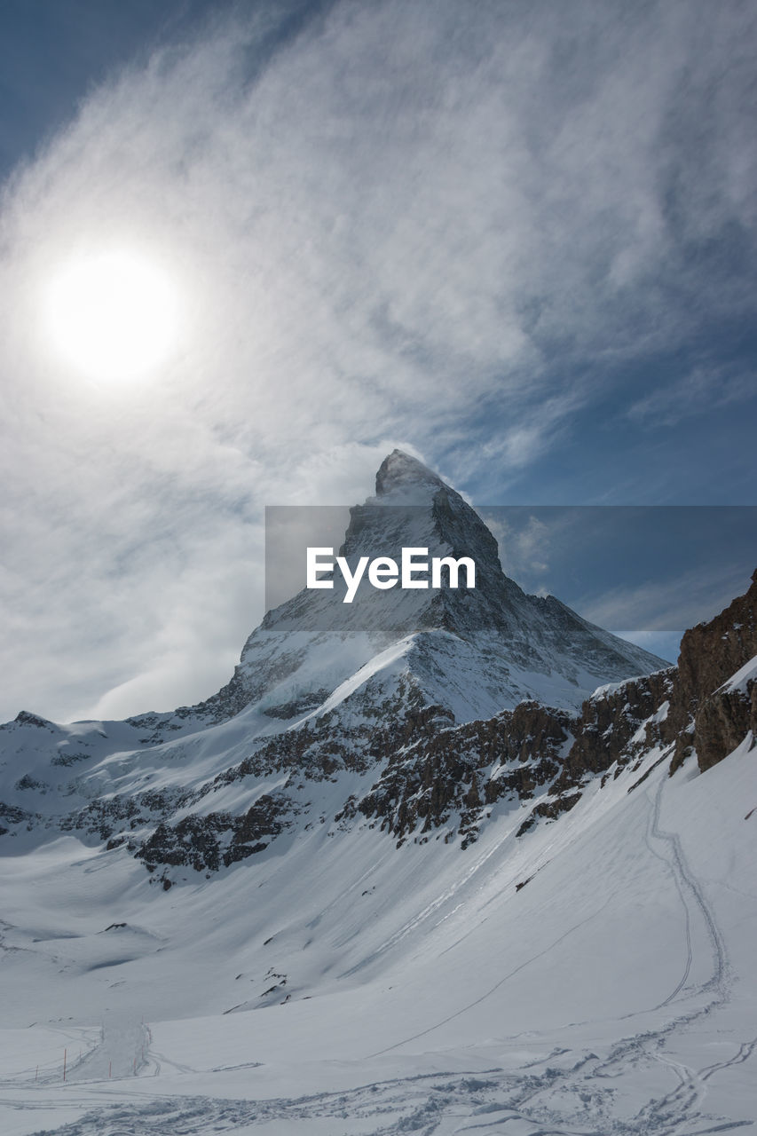 Scenic view of snow covered mountains against sky