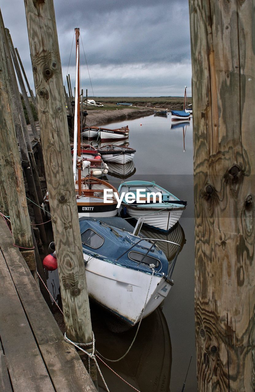Boats moored on sea against sky