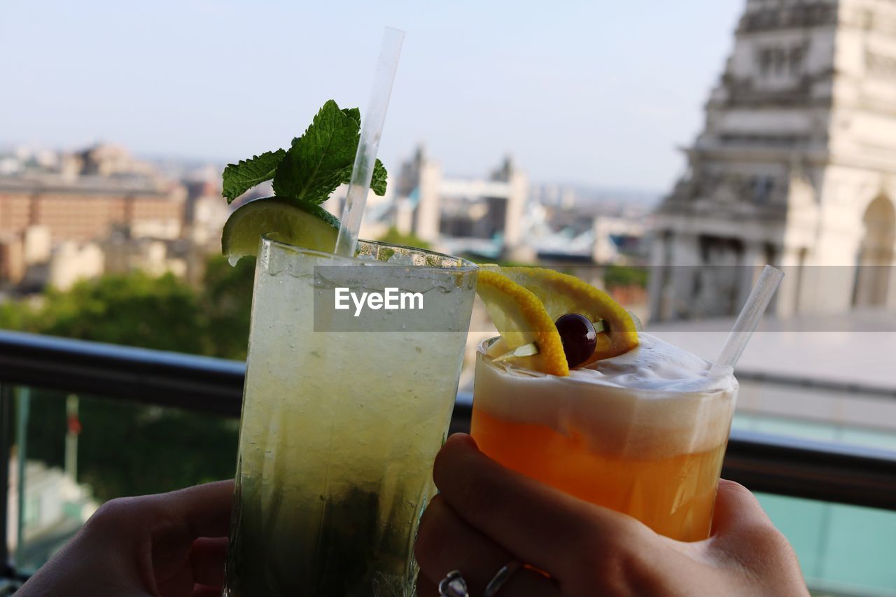 Cropped hands of friends cocktail at restaurant