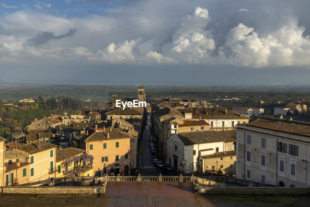 High angle view of buildings in town against sky