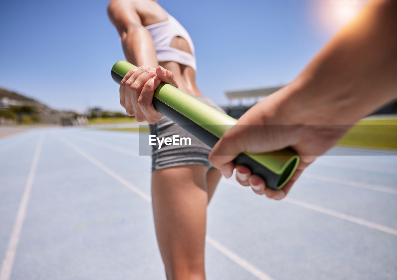 low section of man exercising on track