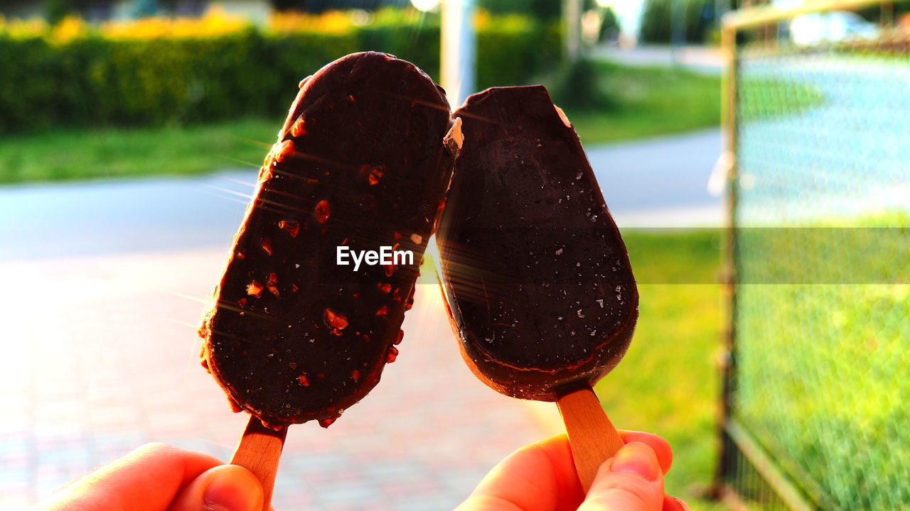 Close-up of hands holding chocolate ice creams