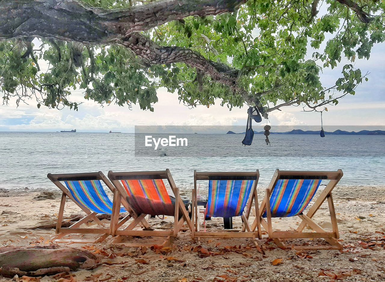 CHAIRS ON BEACH AGAINST SEA