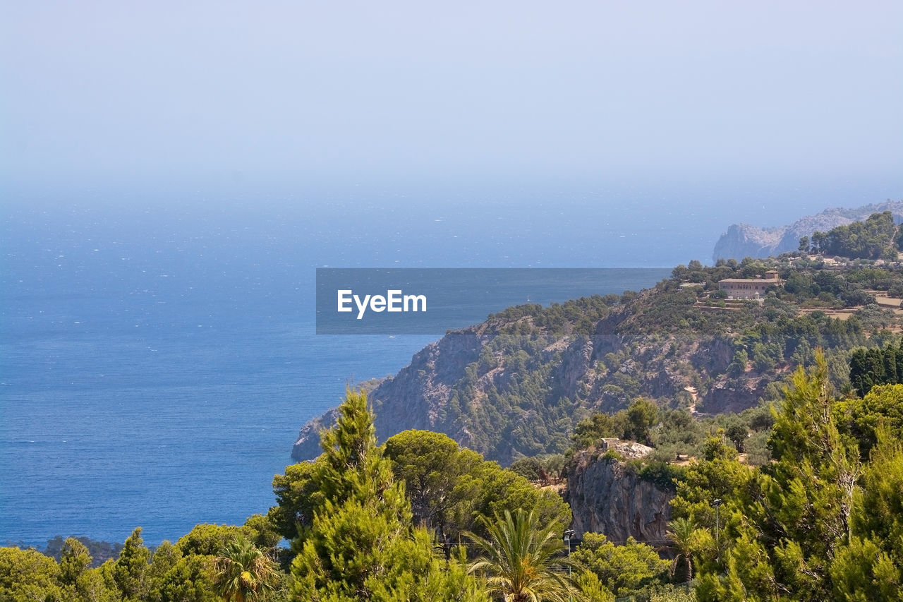 Scenic view of sea and mountains against sky