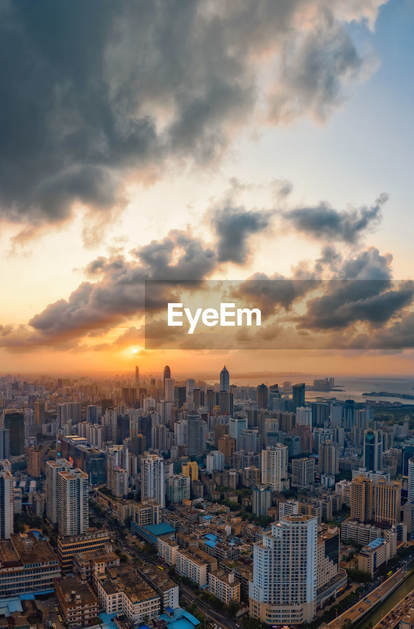 High angle view of buildings in city against sky during sunset