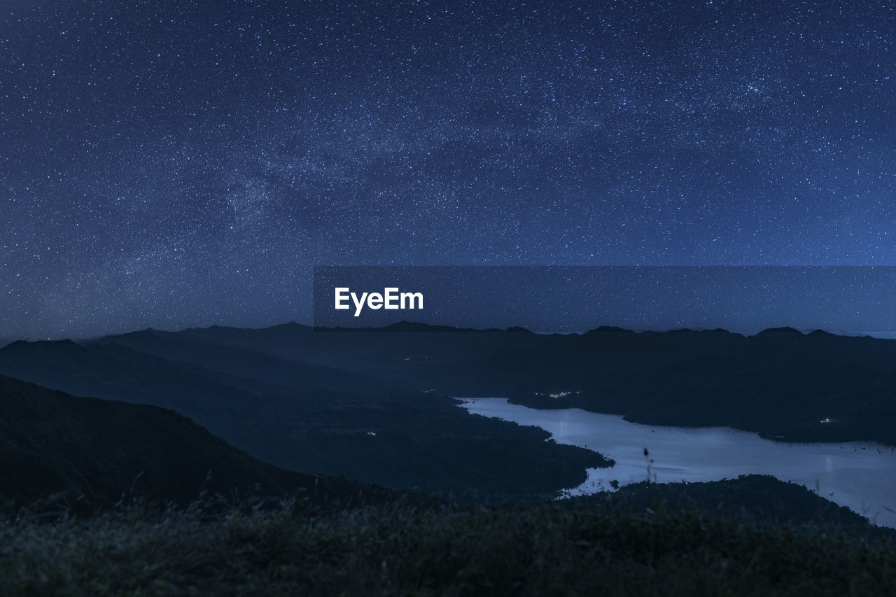 Scenic view of mountains against sky at night