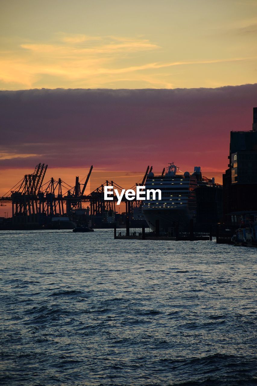 Pier over sea against sky during sunset