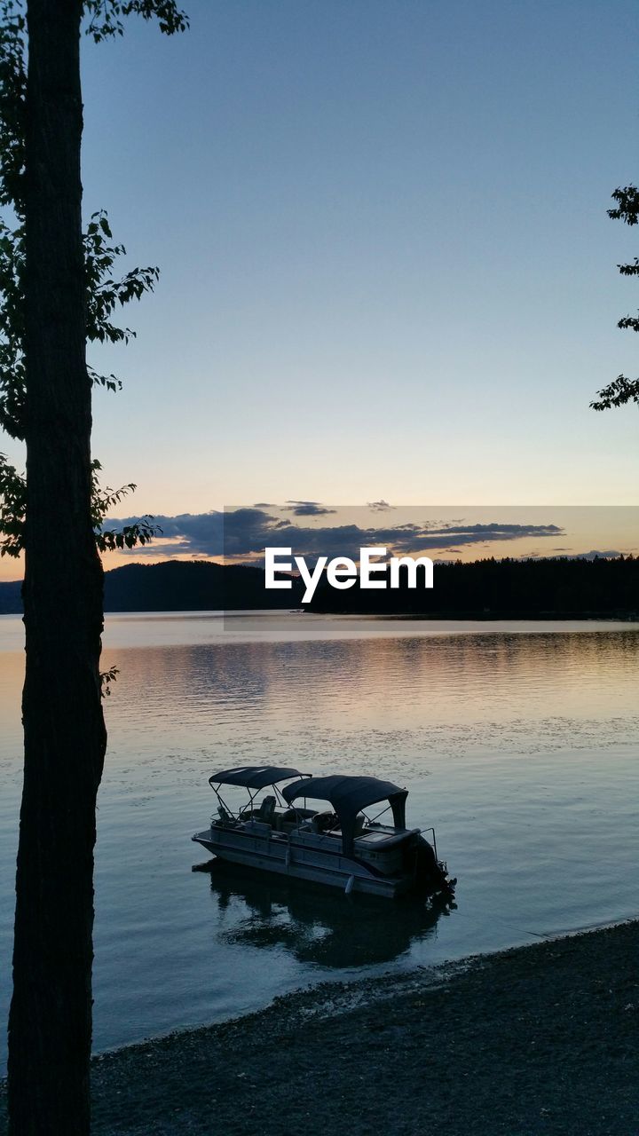 Recreational boat in lake at dusk