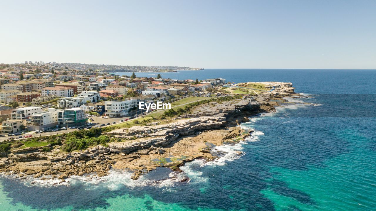 Aerial view of sea against clear sky