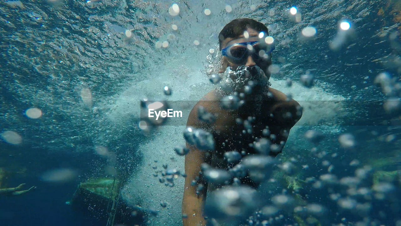 Shirtless man snorkeling in sea