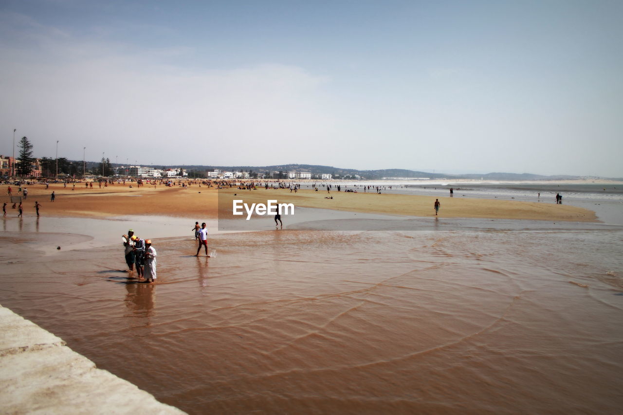 High angle view of people at beach against sky