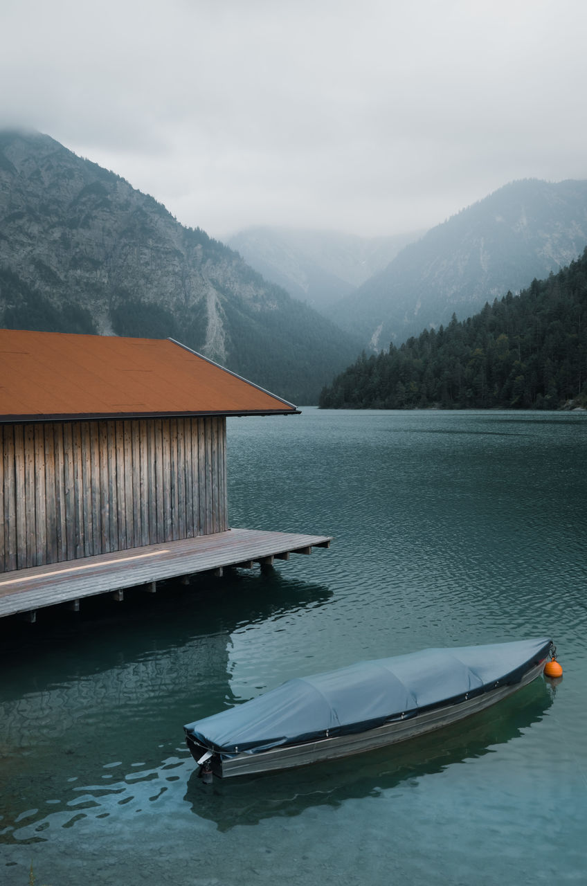 Boat in lake against mountains