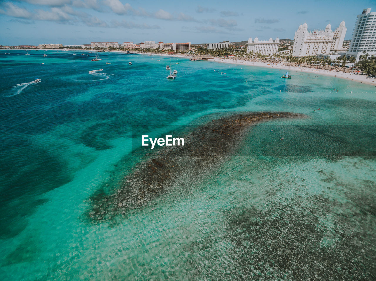 Aerial view of swimming pool by sea against sky