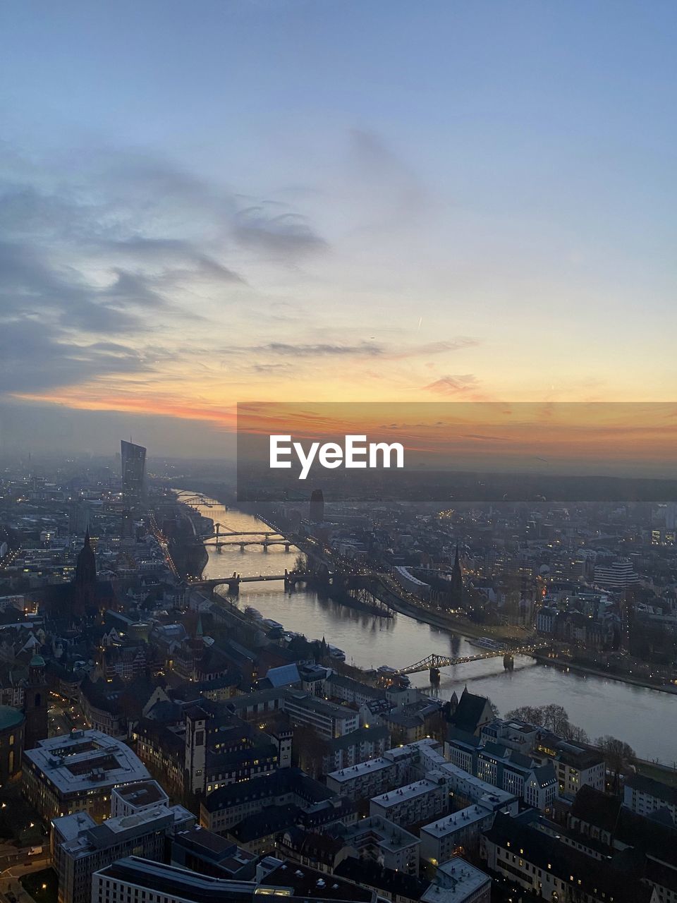 Aerial view of cityscape against sky during sunset