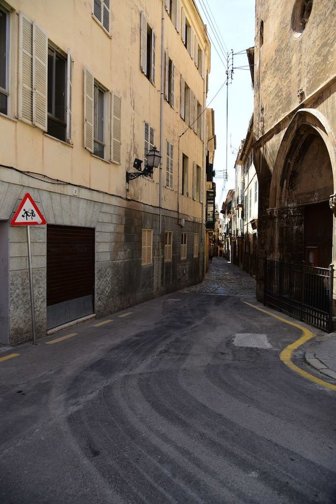 EMPTY ROAD WITH BUILDINGS IN BACKGROUND