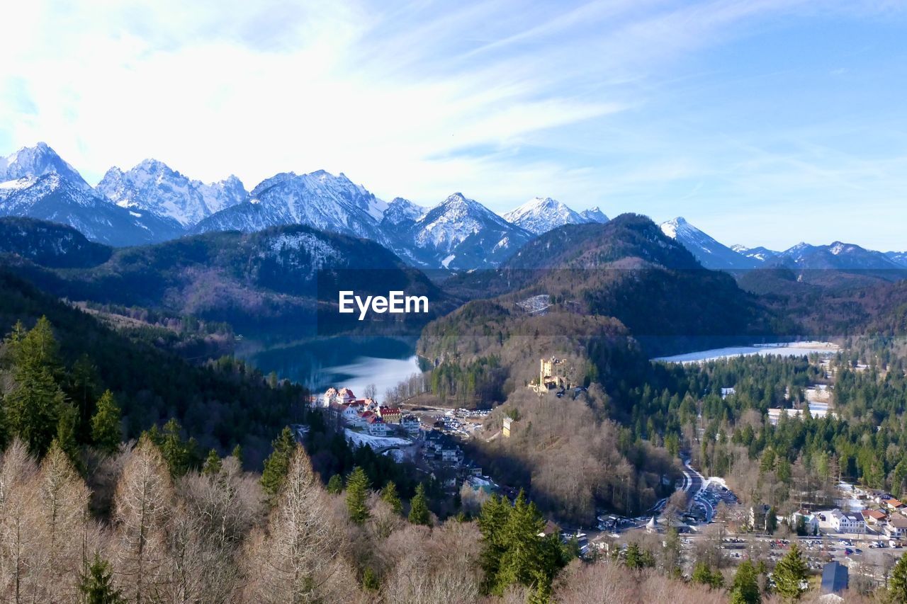 Panoramic view of townscape by mountains against sky