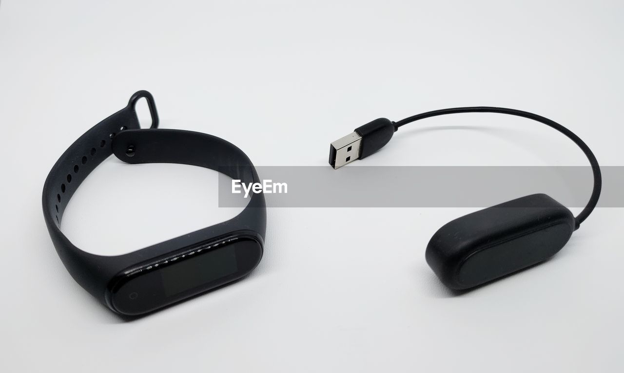 High angle view of smartwatch against white background