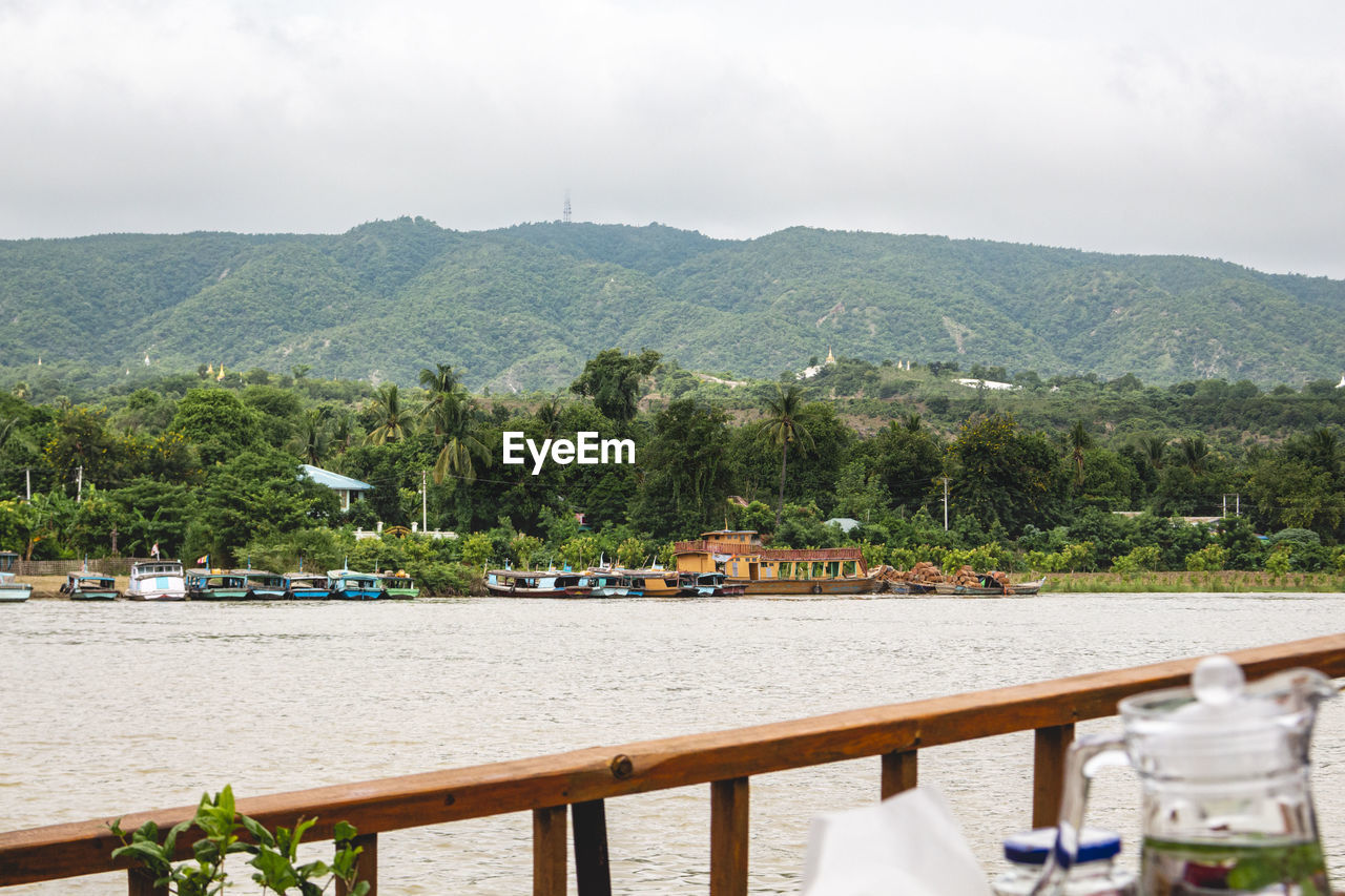 Scenic view of river and mountains against sky