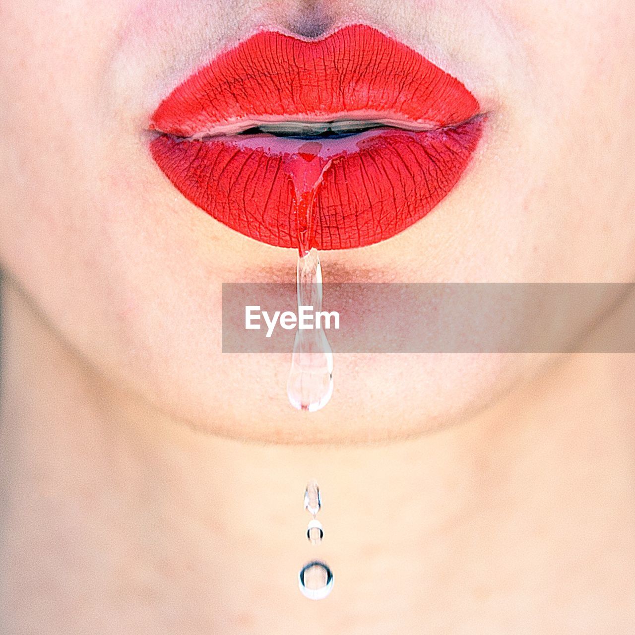 Water flowing through red lips