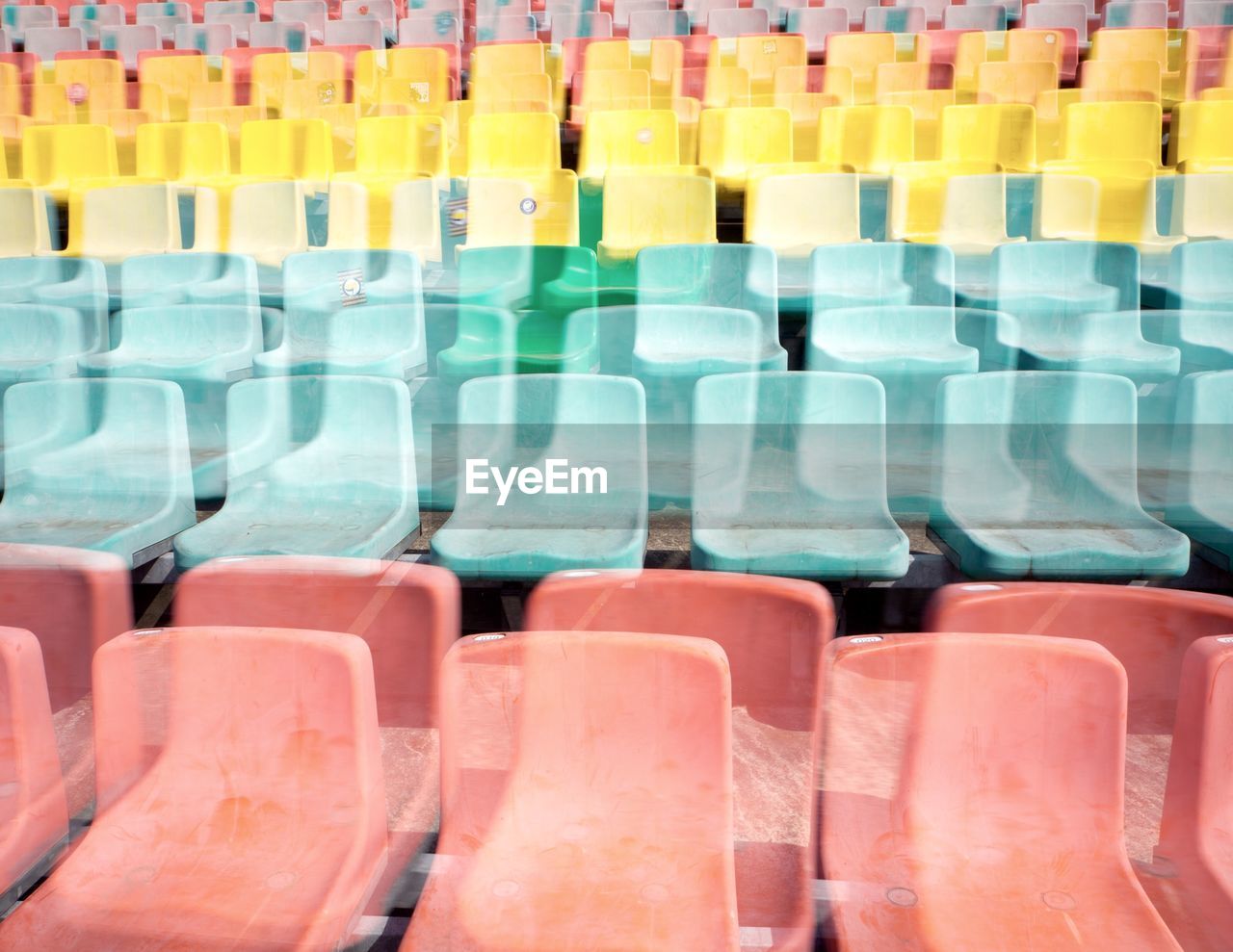 Double exposure image of empty chairs